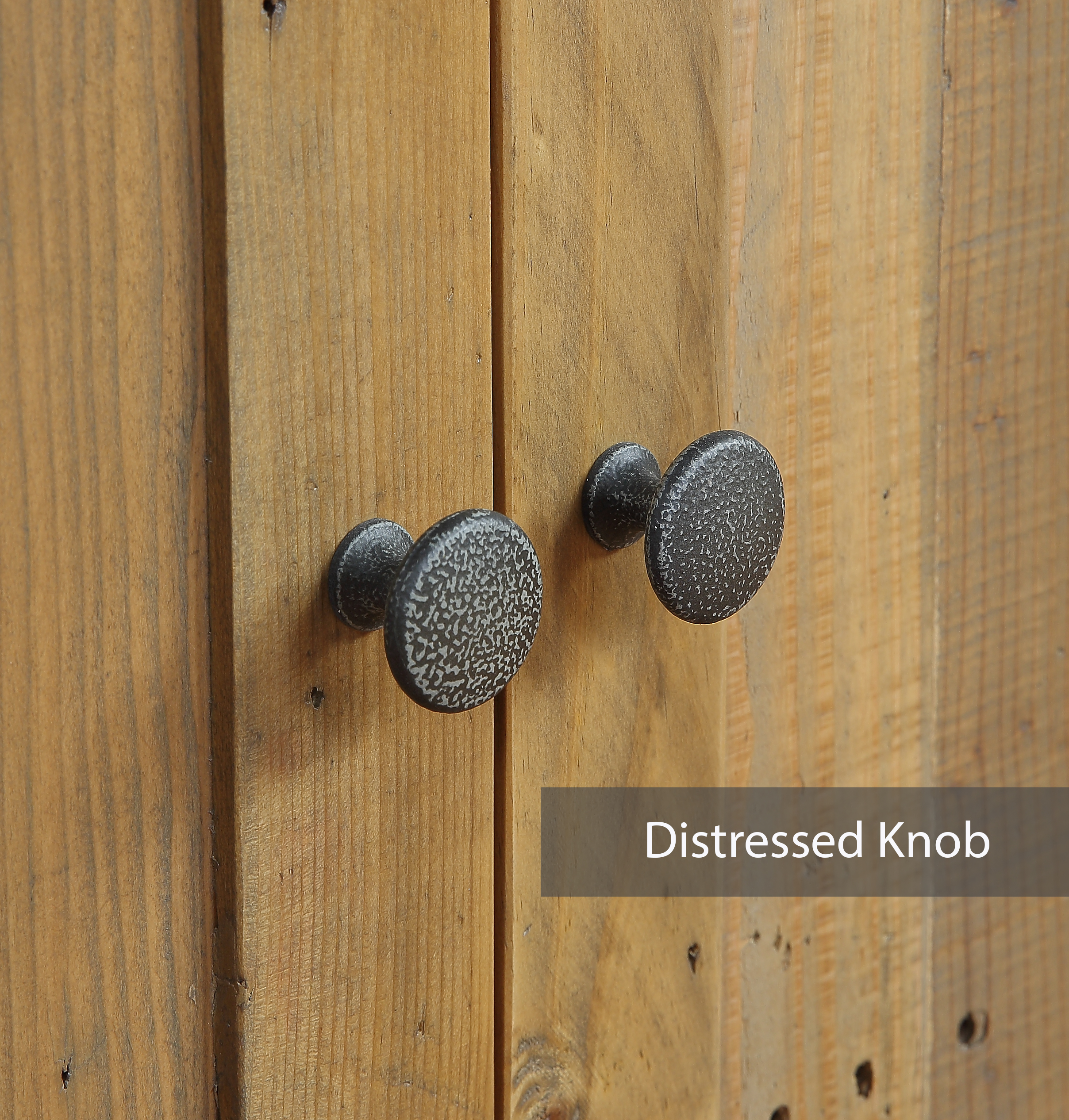 a pair of distressed cupboard door knobs